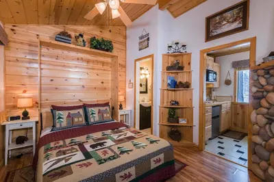 a bedroom with a bed and a wooden wall at Fireside Lodge in South Lake Tahoe