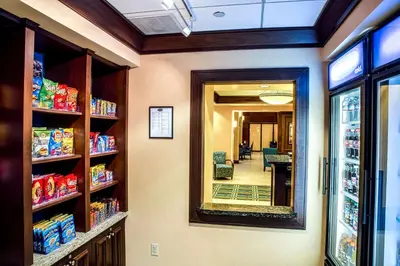 a grocery store aisle with a mirror and a hallway at Hampton Inn & Suites Sacramento-Elk Grove Laguna I-5 in Elk Grove