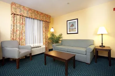 a hotel room with a couch and chairs and a table at Hampton Inn & Suites Sacramento-Elk Grove Laguna I-5 in Elk Grove