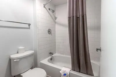a bathroom with a toilet and a tub and a shower at Motel 6-Fresno, CA in Fresno