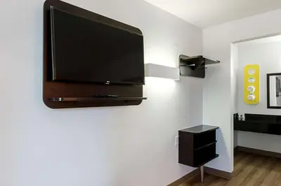 a flat screen tv hanging on a wall at Motel 6-Fresno, CA in Fresno