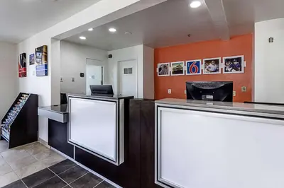 a bar with two blank screens in a room at Motel 6-Fresno, CA in Fresno
