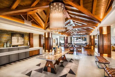 a lobby with wooden ceilings and a table and chairs at Zalanta, A Vail Resorts Property in South Lake Tahoe