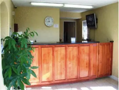 a room with a counter with a clock on the wall at Days Inn by Wyndham Turlock in Turlock