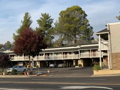 an empty parking lot in front of a hotel at Elmwood Motel in Auburn