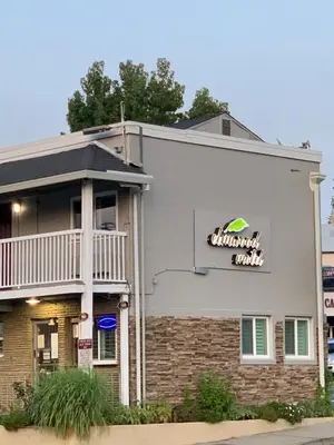 a building with a sign for a restaurant at Elmwood Motel in Auburn
