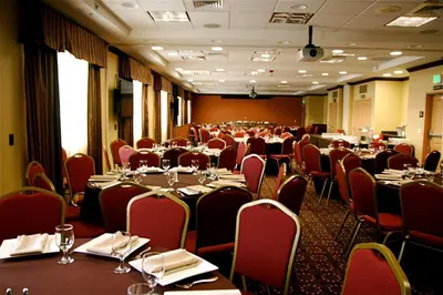 a dining room with tables and chairs at Hampton Inn & Suites Folsom in Folsom