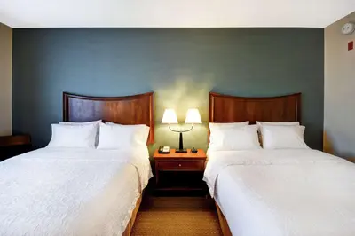 two beds sitting next to each other in a hotel room at Hampton Inn & Suites Folsom in Folsom