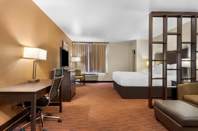 a hotel room with a bed and a desk and a ladder at Comfort Suites Clovis - Fresno in Clovis