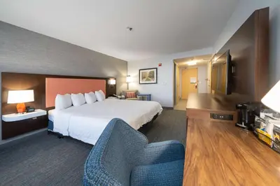 a hotel room with a bed and a couch at Hampton Inn & Suites Modesto - Salida in Modesto
