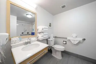 a bathroom with a sink and a toilet and a mirror at Hampton Inn & Suites Modesto - Salida in Modesto