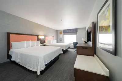 a hotel room with two beds and a television at Hampton Inn & Suites Modesto - Salida in Modesto