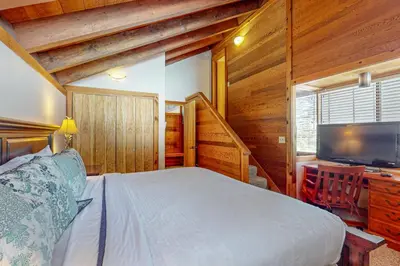 a bedroom with a bed and a desk and a television at Indian Hills Hideaway in Ponderosa Fairway Estates