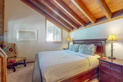 a bedroom with a bed and a desk and a chair at Indian Hills Hideaway in Ponderosa Fairway Estates