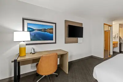 a room with a desk in a hotel room at Comfort Inn South San Jose - Morgan Hill in Morgan Hill