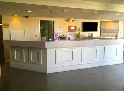 a lobby with a reception counter in a hospital at Studio 6 Suites Delano, CA in Delano