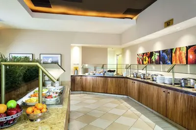 a cafeteria with fruits and vegetables on a counter at Hilton Stockton in Stockton