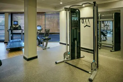 a gym with treadmills and machines in a building at Hilton Stockton in Stockton