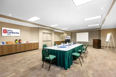 a conference room with a long table and chairs at Hilton Garden Inn Gilroy in Gilroy
