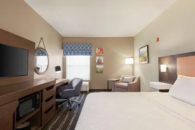 a hotel room with a bed and a desk at Hampton Inn Tracy in Tracy
