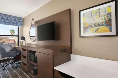a hotel room with a desk with a tv and a desk sidx sidx sidx sidx at Hampton Inn Tracy in Tracy