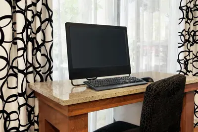 a laptop computer sitting on a desk in front of a window at Hampton Inn Tracy in Tracy