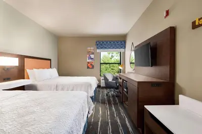 a hotel room with two beds and a flat screen tv at Hampton Inn Sacramento/Rancho Cordova in Rancho Cordova