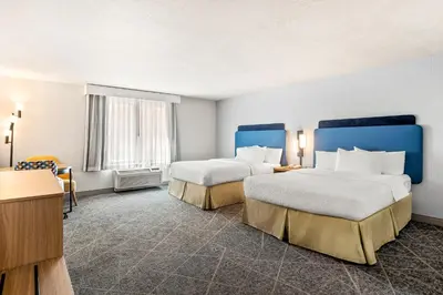 a hotel room with two beds and a desk at Hampton Inn and Suites Merced in Merced