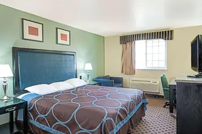 a hotel room with a bed and a desk at Super 8 by Wyndham Sacramento/Florin Rd in Sacramento