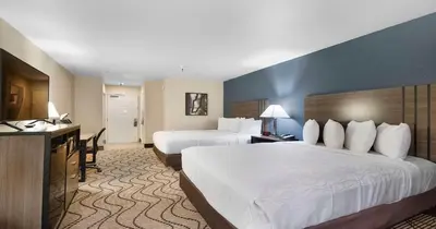 a hotel room with two beds and a television at Best Western Plus Heritage Inn in Stockton