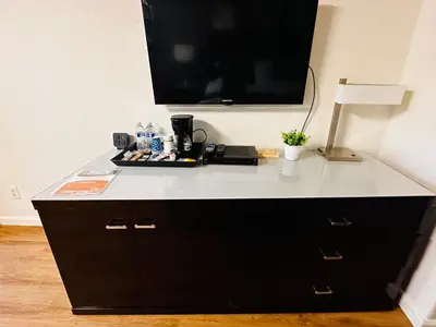 a desk with a flat screen tv on top of it at Sierra Inn in San Andreas