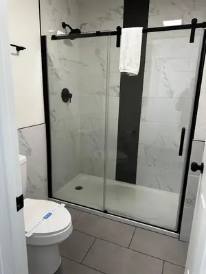 a bathroom with a glass shower with a toilet at Sierra Inn in San Andreas