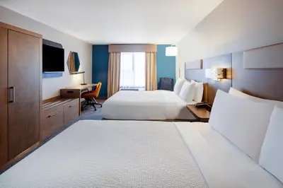 a hotel room with two beds and a desk at Holiday Inn Express Turlock by IHG in Turlock
