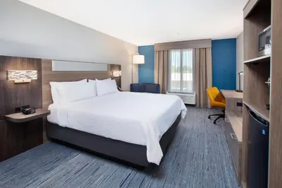a hotel room with a bed and a desk at Holiday Inn Express Turlock by IHG in Turlock