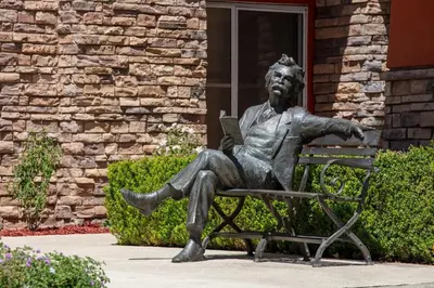 a statue of a man sitting on a bench at Holiday Inn Express Turlock by IHG in Turlock