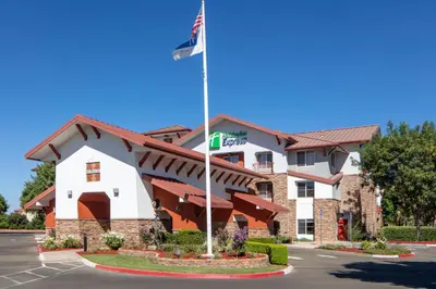 a front view of a hotel with a flag at Holiday Inn Express Turlock by IHG in Turlock
