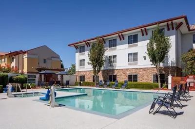 a swimming pool in front of a building at Holiday Inn Express Turlock by IHG in Turlock