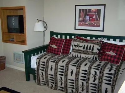 a bedroom with a bed with pillows and a television at Rr-interlaken 05 in June Lake