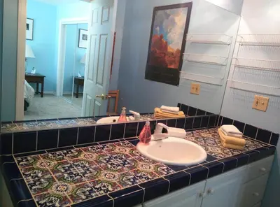 a bathroom with a sink and a mirror at Suite Sunshine in Yosemite West