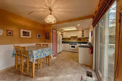 a kitchen with a table and chairs in a room at Suite Sunshine in Yosemite West