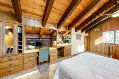 a bedroom with wooden walls and a bed in a room at Mammoth Pines 11 in Mammoth Lakes