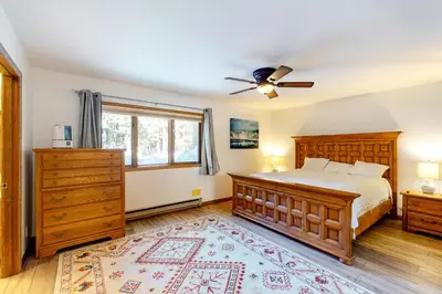 a bedroom with a bed and a ceiling fan at Mammoth Pines 11 in Mammoth Lakes
