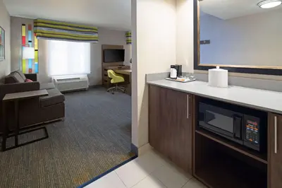 a hotel room with a kitchen and a living room at Hampton Inn Visalia in Visalia