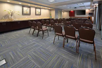 a conference room with a row of chairs and a podium at Hampton Inn Visalia in Visalia
