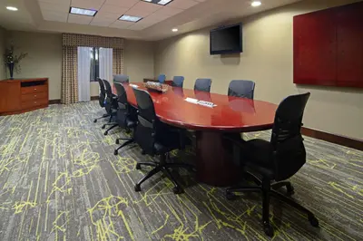 a conference room with a long table and chairs at Hampton Inn Visalia in Visalia