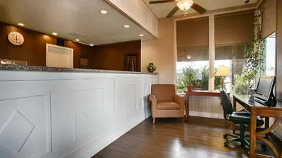 an office with a bar and a desk and chairs at Days Inn & Suites by Wyndham Lodi in Lodi