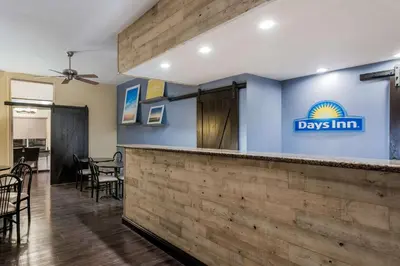 a bar with a days inn sign on a wall at Days Inn & Suites by Wyndham Lodi in Lodi