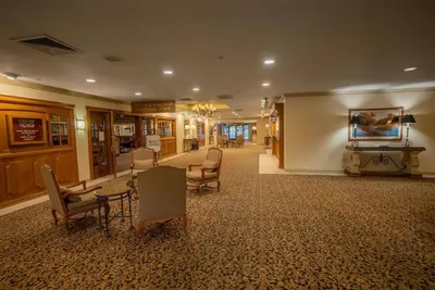 a lobby with chairs and tables in a building at Piccadilly Inn Airport in Fresno