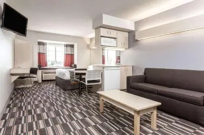 a small living room with a couch and a table at Microtel Inn & Suites Modesto in Ceres