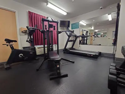 a gym with several tread machines and a mirror at Microtel Inn & Suites Modesto in Ceres